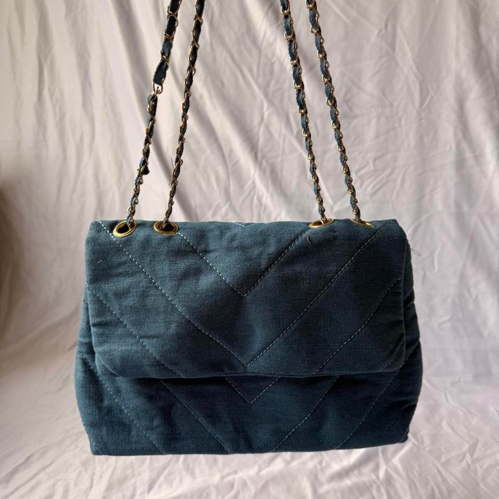 Blue denim quilted handbag with gold hardware and chain strap